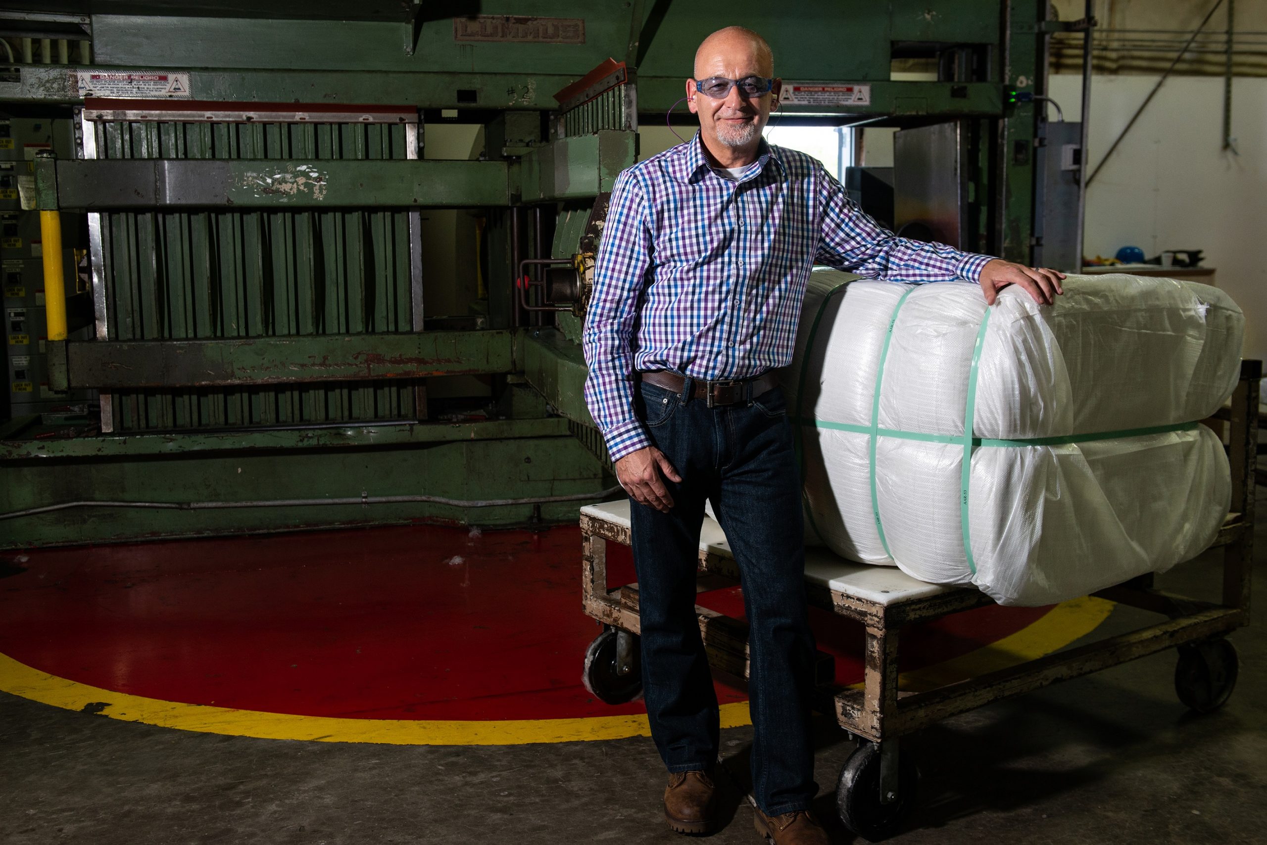 PrimaLoft Product Engineer Robert Dempsey with the first bale of fine denier high performance PrimaLoft biodegradable fibre