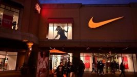 In this photo taken on May 21, 2019 shows shoppers at an outlet mall exit a Nike store in Los Angeles. AFP GETTY IMAGES